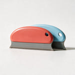FurLift pet hair remover combs in red and light blue — studio packshot
